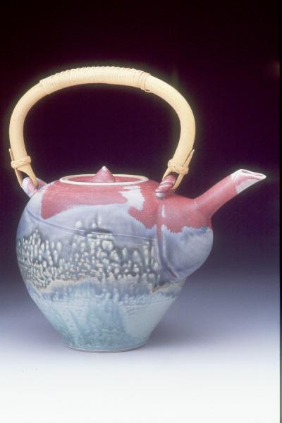 Sager glaze teapot with rattan handle.